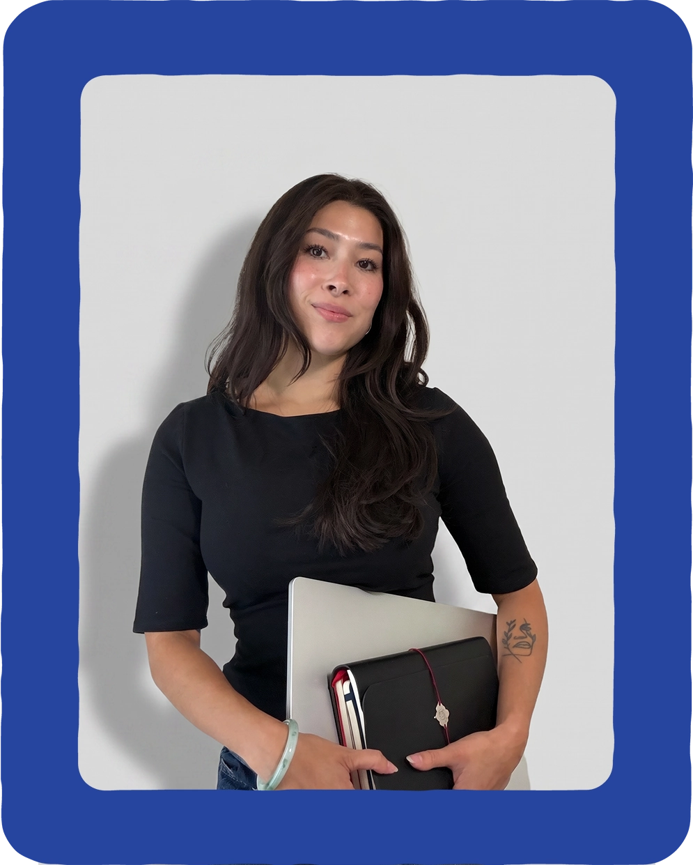 Talia Coeshott, website design expert at Avren Studio, holding a laptop
